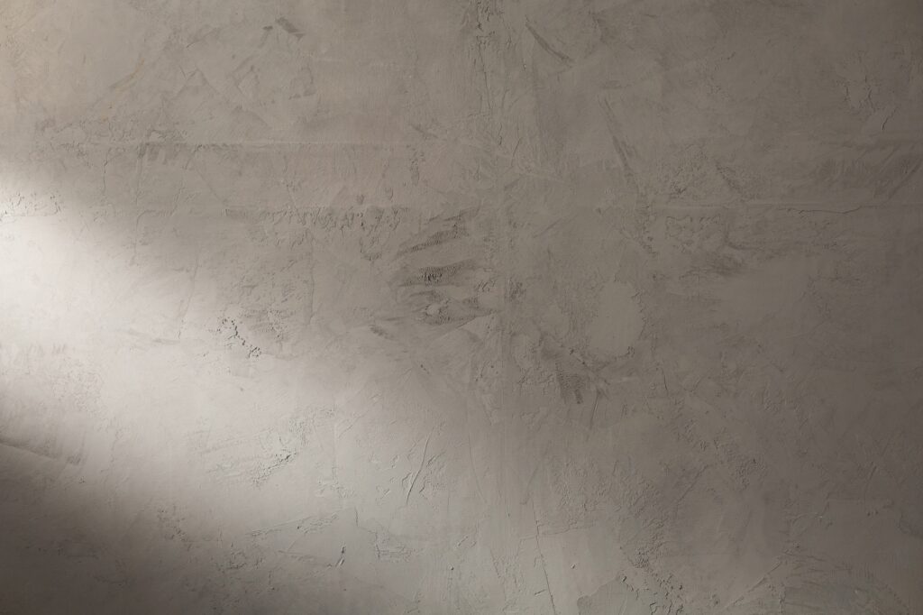 Abstract grey plaster wall background texture. Plaster surface front view
